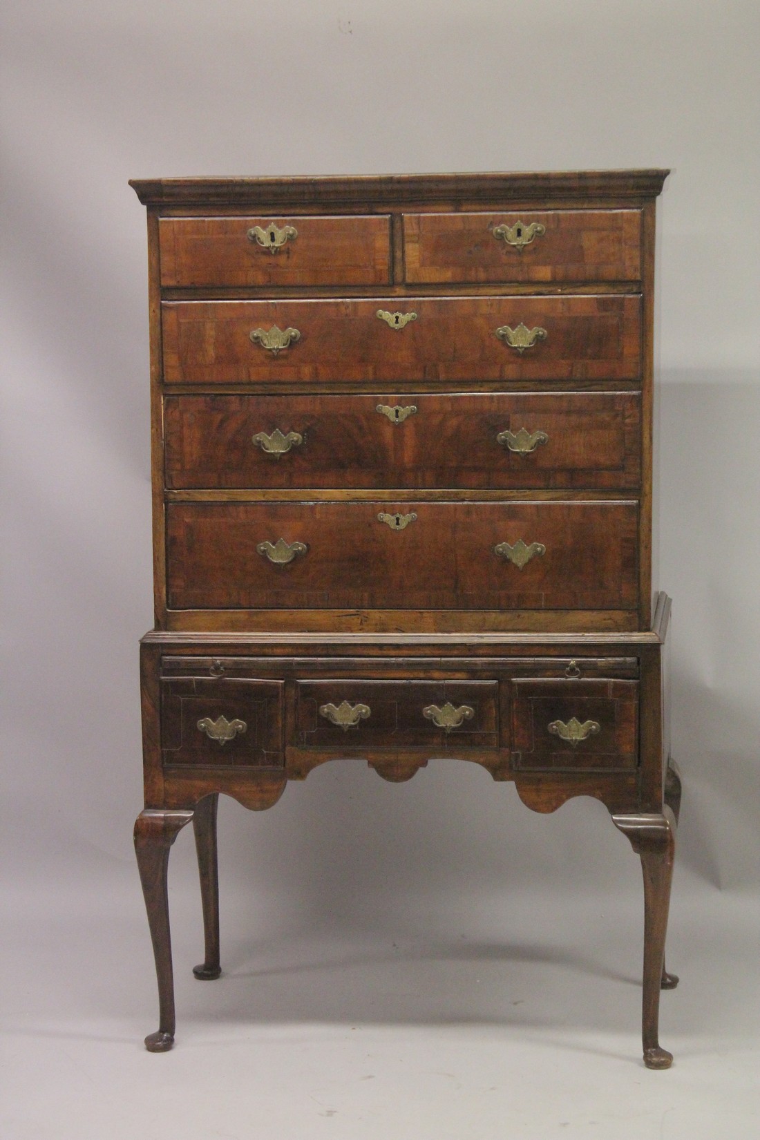 AN 18TH CENTURY OAK AND WALNUT CHEST ON STAND the top with two short and three long graduated