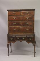 AN 18TH CENTURY OAK AND WALNUT CHEST ON STAND the top with two short and three long graduated