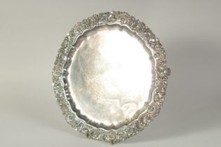 AN OLD SHEFFIELD PLATE CIRCULAR SALVER with shell and scroll cast border. 10ins diameter and a