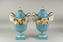 A LARGE PAIR OF SEVRES LIGHT BLUE TWO HANDLED URN SHAPE PORCELAIN VASES with rams mask handles and