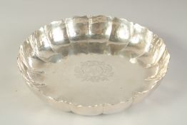 A GEORGE III SILVER STRAWBERRY DISH of typical lobed form, engraved to the centre with an
