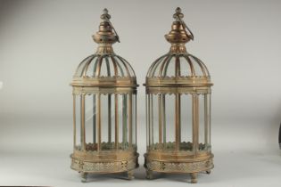 A PAIR OF COPPER AND GLASS HANGING LANTERNS. 2ft high 9ins diameter.