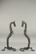 A PAIR OF CHINESE BRONZE DRAGONS. 1ft 4ins high.