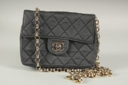 A SMALL CHANEL PADDED BLACK LEATHER HAND BAG, 7ins with long gilt handle.