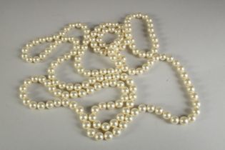 A LONG PEARL NECKLACE. 60ins long.