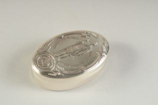 A SILVER OVAL SHAPED PILL BOX the cover embossed with a military figure 2ins long.