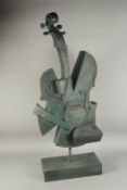 A LARGE ABSTRACT BRONZE CELLO on a stand. 3ft 2ins high.