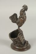 AUGUSTE NICHOLAS CAIN (1822 - 1994) FRENCH. A BRONZE COCKERAL STANDING IN A FARMYARD BASKET with a