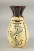 A HUNGARIAN ART POTTERY MISKO WINE JUG with a man's face and snake. Signed. 9ins high.