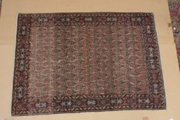A GOOD PERSIAN RUG cream ground with stylised Boteh design. 6ft 5ins x 4ft 8ins.