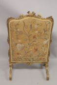 A FRENCH CARVED AND GILDED FIRE SCREEN with needlework panel. 3ft 6ins high, 2ft wide.