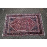 A GOOD PERSIAN CARPET red ground with all over stylised decoraction. 8ft 8ins x 5ft 4ins.