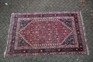 A GOOD PERSIAN CARPET red ground with all over stylised decoraction. 8ft 8ins x 5ft 4ins.