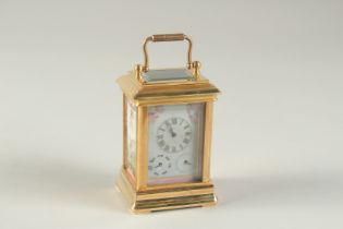 A MINIATURE "SEVRES" STYLE CARRIAGE CLOCK with porcelain dial and panels. 3.75ins high including