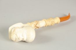 A LARGE MEERSCHAMP PIPE, the bowl, the head of Arab men with amber mouth piece. 6ins long.