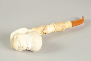 A LARGE MEERSCHAMP PIPE, the bowl, the head of Arab men with amber mouth piece. 6ins long.