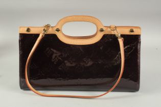 A LOUIS VUITTON BLACK PATENT LEATHER BAG. 12ins long.