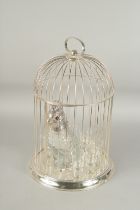 A GOOD SILVER PLATED BIRDCAGE DECANTER SET, a parakeet and six glasses. 18ins high, 11 ins