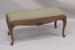 A VICTORIAN ROSEWOOD LONG PADDED TOP STOOL supported on cabriole legs. 3ft 6ins long, 1ft 6ins wide,