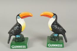 A PAIR OF BLACK AND WHITE PAINTED CAST IRON GUINNESS TOUCANS 5.5ins high.