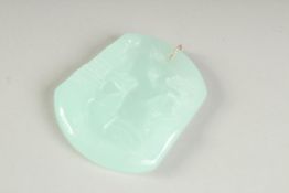 AN ICY CARVED CHINESE PENDANT. 2.25ins x 1.75ins.