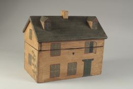 A DECORATIVE PAINTED BOX OR TEA CADDY, modelled as a cottage. 10ins long.