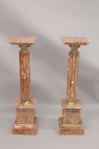 A GOOD PAIR OF PINK MARBLE CLUSTER COLUMNS with square tops and pedestal bases. 3ft 4ins high.