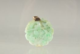 A GOLD PLATED TOP AND CARVED CIRCULAR JADE PENDANT. 1.75ins diameter.