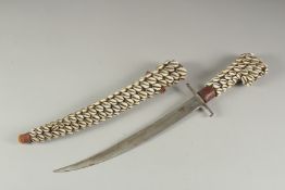 A COWIE SHELL COVERED DAGGER AND SHEATH. 19ins long.