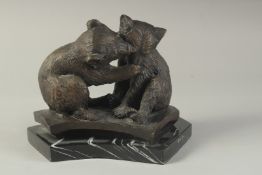 A CAST BRONZE GROUP OF TWO PLAYFUL BEARS on a marble base. 7ins high.