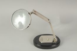A CHROME MAGNIFYING GLASS on a stand