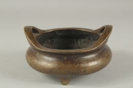 A CHINESE BRONZE CIRCULAR TWO HANDLED CENSER. 4.75ins diameter.