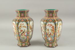 A PAIR OF CHINESE RICH BLUE AND GILT PORCELAIN VASES with panels of flowers. 10ins high.