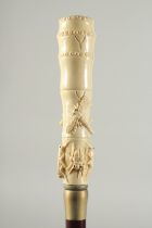 A CARVED BONE HANDLE WALKING STICK "INSECTS". 2ft 11ins long.