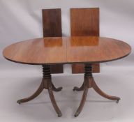 A GEORGIAN MAHOGANY 'D' END DOUBLE PILLAR DINING TABLE with two loose leaves, plain top, reeded