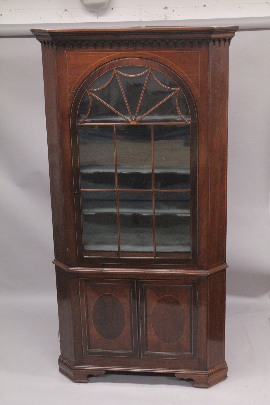 A GOOD GEORGE III MAHOGANY STANDING CORNER CUPBOARD the top with glass door enclosing two shaped