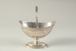 A GEORGE III SILVER BOAT SHAPE SUGAR BASKET, chased body and swing handle. London 1790. Maker: C.