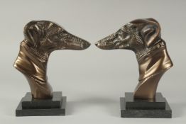 A PAIR OF BRONZE GREYHOUNDS HEADS on stepped bases. 8.5ins high.