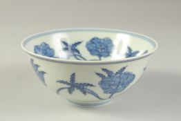 A CHINESE BLUE AND WHITE PORCELAIN BOWL painted with flower heads. 15cm diameter.