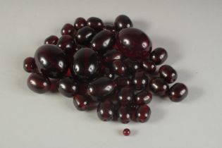 A QUANTITY OF CHERRY AMBER BEADS. 150gms.