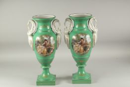 A PAIR OF SEVRES STYLE GREEN GROUP TWO HANDLED PORCELAIN VASES with swan handles and reverse