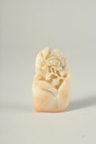 A CHINESE CARVED HARDSTONE SEAL, a bird and a flower. 2.75ins long.