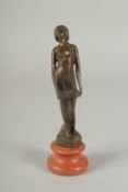 A SMALL BRONZE DECO STYLE NUDE on a circular base. 8ins high.