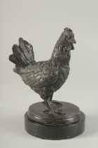 A BRONZE MODEL OF A CHICKEN on a circular marble base. 7.5ins high.