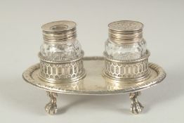 A GOOD EARLY GEORGE III TWO BOTTLED INKSTAND with pierced bottle holders, supported on four claw and