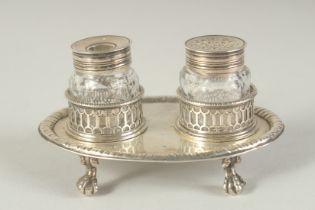 A GOOD EARLY GEORGE III TWO BOTTLED INKSTAND with pierced bottle holders, supported on four claw and