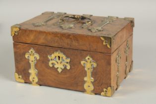 A GOOD 19TH CENTURY FIGURED WALNUT BRASS BOUND CASKET with velvet interior. 8ins long.