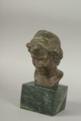 A BRONZE BUST OF A BOY on a square marble base. 5ins high.