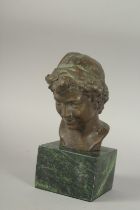 A BRONZE BUST OF A BOY on a square marble base. 5ins high.