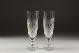 A PAIR OF CUT GLASS WINE FLUTES.